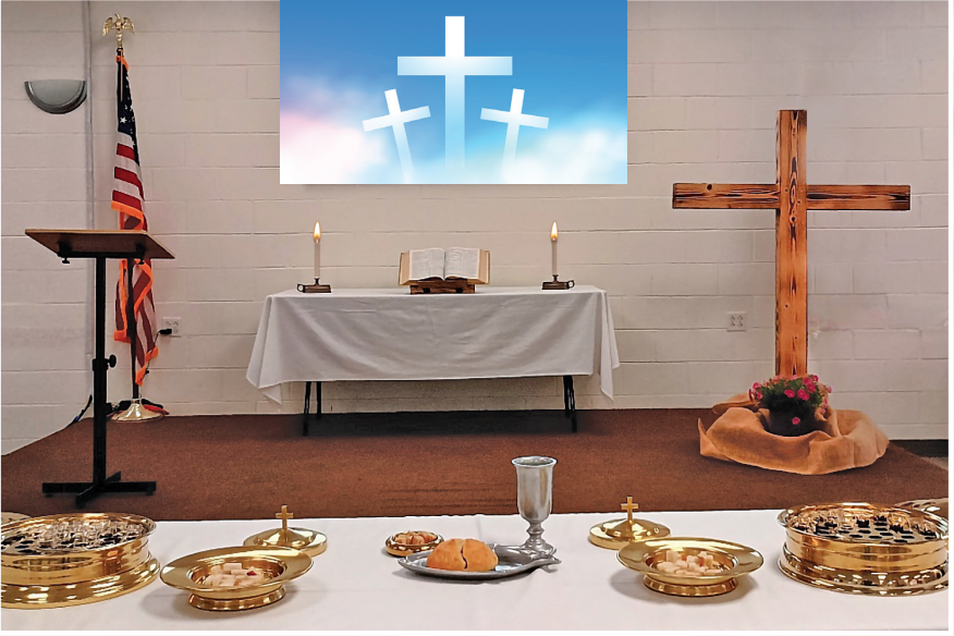 Communion alter set with a cross behind the table and space ready for service